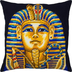 May include: A black pillow with a gold and blue embroidered image of an Egyptian pharaoh's head.