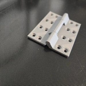 May include: A light gray rectangular hinge featuring two flat plates connected by a central cylindrical pivot point. Each plate contains eight countersunk screw holes arranged in two parallel rows, providing a secure mounting surface for hardware.