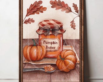 May include: A framed watercolor print featuring a glass jar of orange pumpkin butter with a red and white checkered lid, two orange pumpkins, a small spoon with a dollop of butter, and brown oak leaves on a wooden table surface.