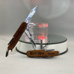 May include: Two multi-tools with wooden handles and engraved text. The first tool has the text "Digital Impressions" engraved on the handle. The second tool has the text "Best Man Richard" engraved on the handle.