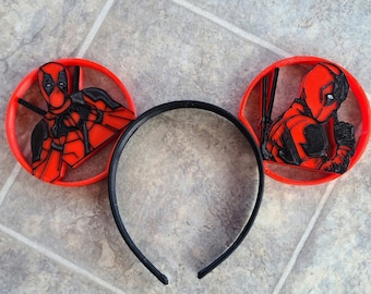 May include: Red and black 3D printed headband with a Deadpool character on each side.