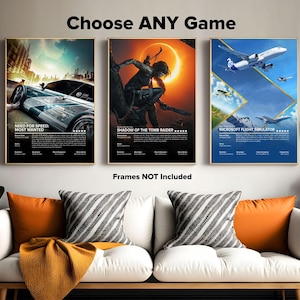 May include: Three video game posters with a white background and black text. The posters are for Need for Speed Most Wanted, Shadow of the Tomb Raider, and Microsoft Flight Simulator. The posters are framed and hanging on a wall.