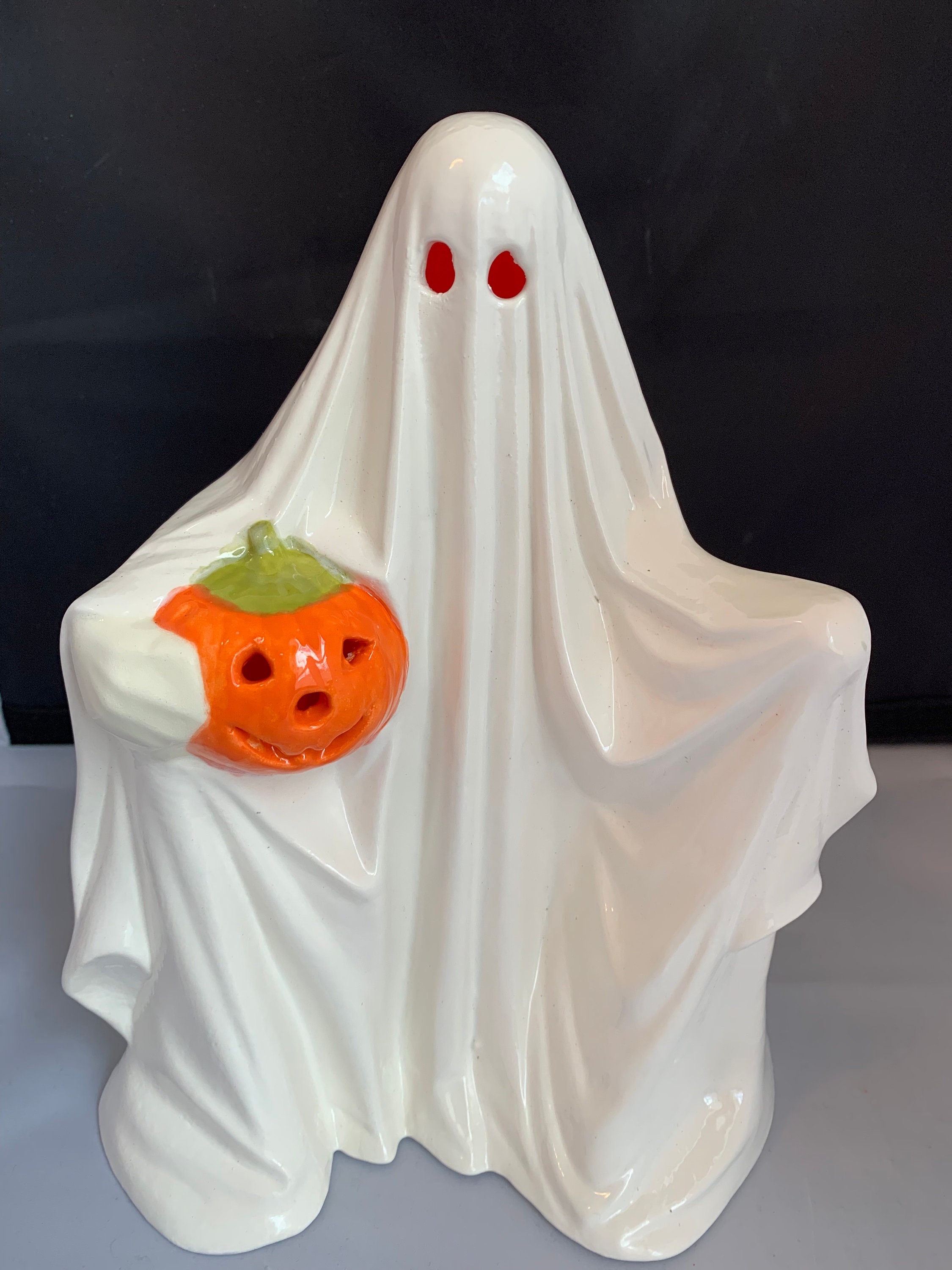 Ghost holding pumpkin