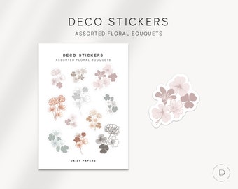 May include: A sheet of stickers featuring various floral bouquets in shades of brown, pink, and grey. The stickers are labelled "Deco Stickers, Assorted Floral Bouquets, Daisy Papers".