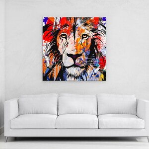 May include: A colourful abstract painting of a lion's face with splashes of red, orange, yellow, blue, and black paint.