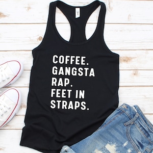 May include: Black tank top with white text that reads "Coffee. Gangsta Rap. Feet in Straps."
