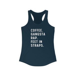 May include: A navy blue racerback tank top with the text "COFFEE. GANGSTA RAP. FEET IN STRAPS." printed in white.
