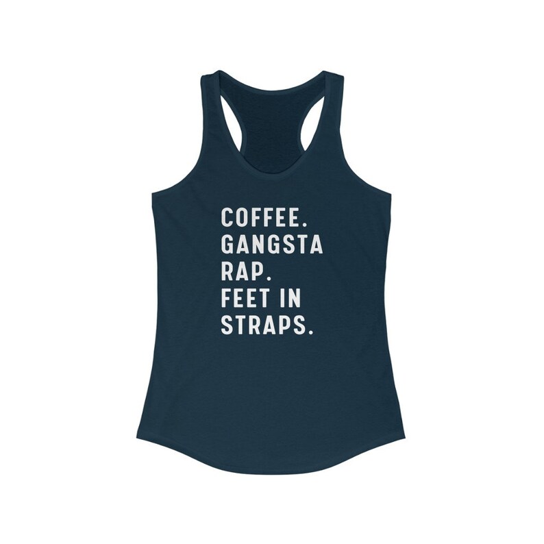 May include: A navy blue racerback tank top with the text "COFFEE. GANGSTA RAP. FEET IN STRAPS." printed in white.