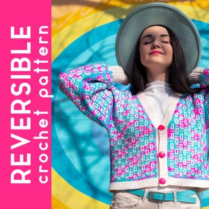 May include: A colorful crochet cardigan with a turquoise, pink, and white pattern. The cardigan has a V-neck, pink buttons, and a turquoise belt. The image also features the text "REVERSIBLE crochet pattern" in a vertical pink bar.