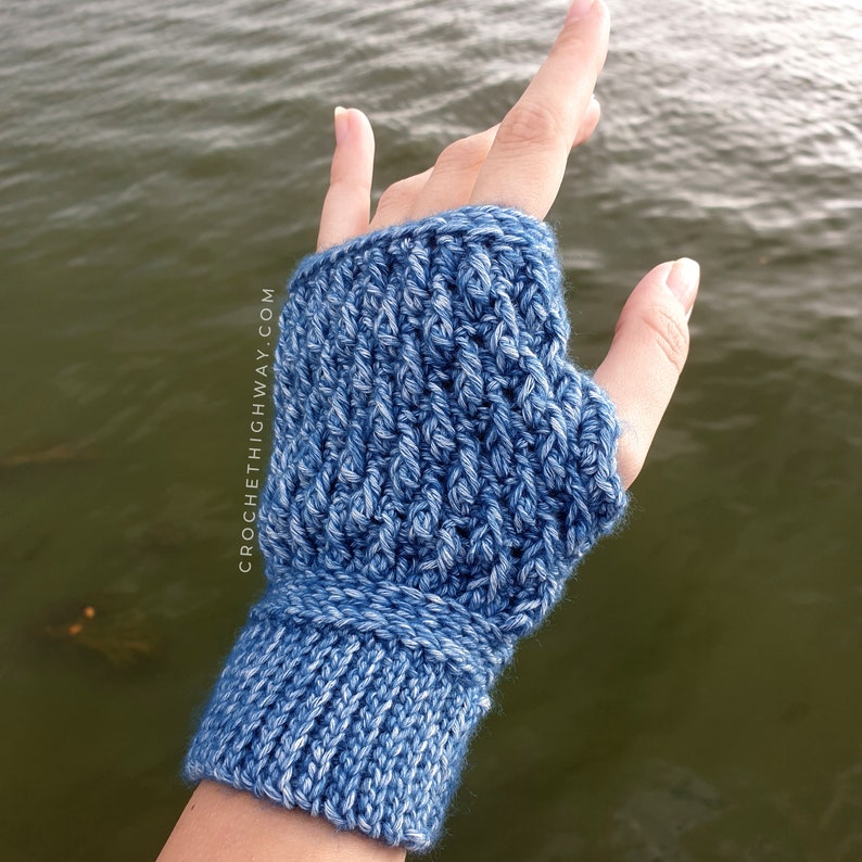 May include: Blue crocheted fingerless gloves with a ribbed cuff. The gloves are made with a textured stitch pattern.