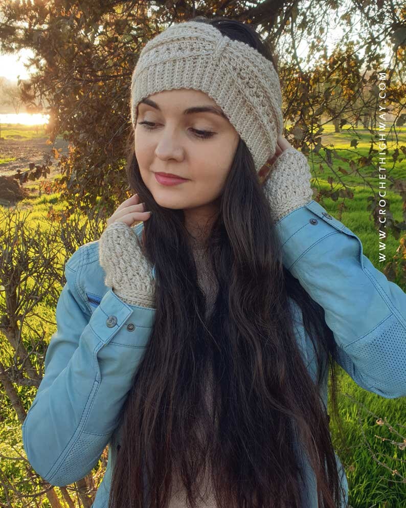 May include: A woman wearing a beige crocheted ear warmer headband and matching fingerless gloves. The headband has a criss-cross pattern and the gloves have a simple stitch.