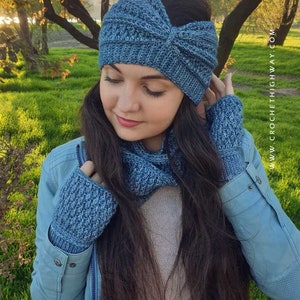 May include: A blue crocheted headband, neck warmer, and fingerless gloves set. The headband has a knot on top. The set is made with a textured stitch.