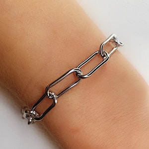 May include: A silver chain bracelet with large oval links.