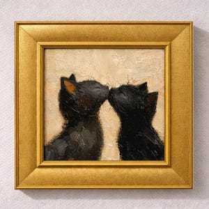 May include: A framed oil painting depicts two black cats touching noses. The cats are painted with visible brushstrokes, and the painting is set against a neutral background. The frame is a gold color, adding a touch of elegance to the artwork.