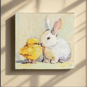 May include: Square canvas art featuring a white rabbit and a yellow chick in a textured, impasto style. The rabbit has pink-lined ears, and the chick is positioned close to the rabbit. The background is a soft, pale yellow.