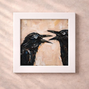 May include: A square painting in a white frame depicting two black crows facing each other with open beaks. The birds are rendered with visible brushstrokes against a textured, light beige background, capturing their dark plumage and alert eyes.