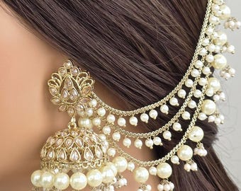 May include: Gold-toned, ornate earring with a pearl-like bead design. The earring features a floral-inspired top with a dangling chain of pearls that attaches to the hair. The lower portion of the earring is a bell shape, also adorned with pearls.