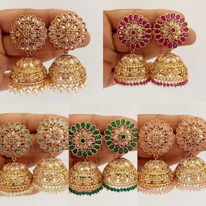 May include: Ornate gold-coloured earrings with a floral design. The earrings have a large, domed bell shape with detailed patterns and a flower-shaped top. Some pairs feature pearl or gemstone accents in various colours.