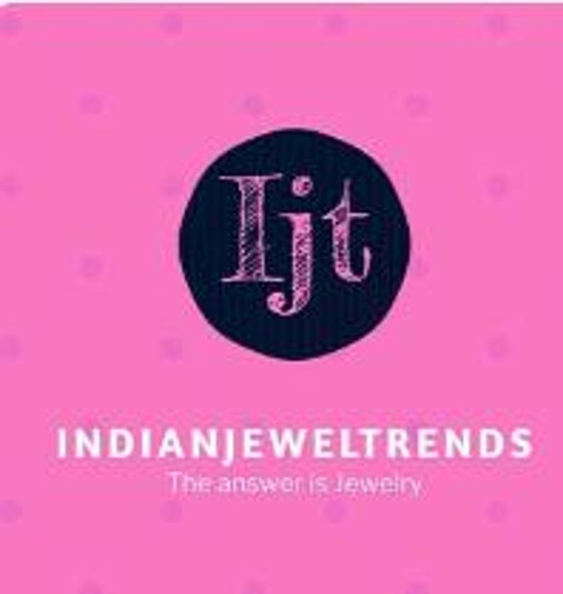 May include: A black circle with the letters "Ijt" in white inside. The text "INDIANJEWELTRENDS" is below the circle in black text. The text "The answer is Jewelry" is below the text "INDIANJEWELTRENDS" in smaller black text.