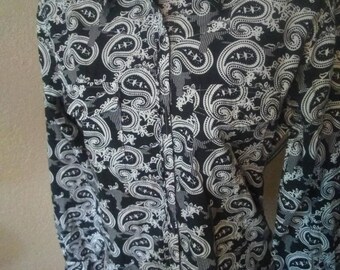 May include: A black and white paisley print long-sleeve button-up shirt.