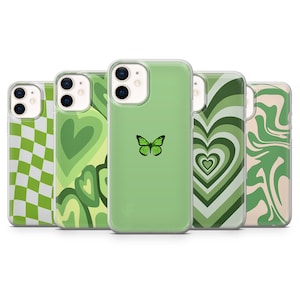 May include: Five different green phone cases with various designs. The designs include a chequered pattern, a swirl pattern, a heart pattern, a butterfly, and a marble pattern.