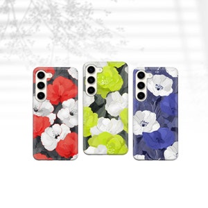 May include: Three phone cases with floral designs. The first case has red, white, and black flowers. The second case has green, white, and black flowers. The third case has blue, white, and black flowers.