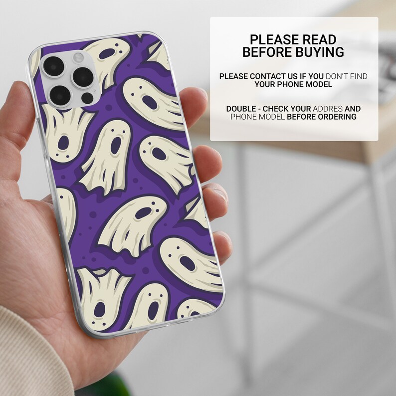May include: A clear phone case with a purple background and a white ghost pattern. The case is designed for a phone with a triple camera lens.