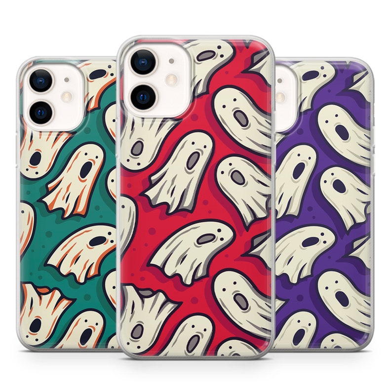 May include: Three clear phone cases with a ghost pattern. The cases are red, green, and purple. Each case has a different ghost pattern.