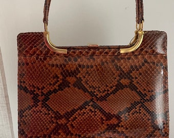 vintage ladies handbag in snake look.