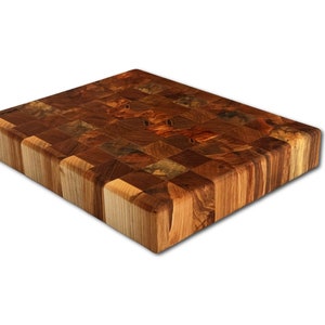 May include: A large, rectangular wooden cutting board made of various wood types. The board has a checkered pattern and a natural wood finish.