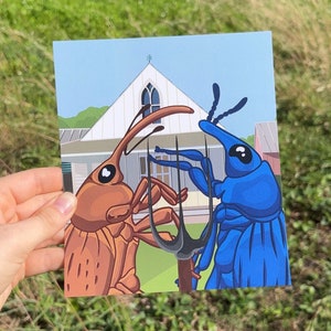 May include: A postcard illustration of two cartoon beetles, one brown and one blue, standing on a black garden fork in front of a white house with a blue roof.