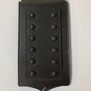 May include: Black leather motorcycle gas tank cover with a row of metal studs.