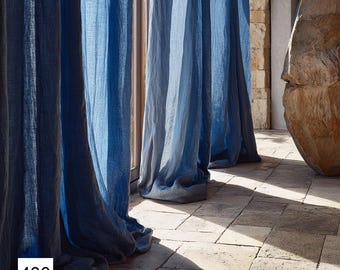 May include: Blue linen curtains hang in front of a window, with sunlight streaming through. The curtains have a textured appearance and a gradient of blue hues. The number "400" is visible in the lower left corner.