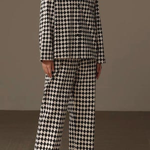 May include: Black and white checkered pajama set with a long-sleeved shirt and wide-leg pants.