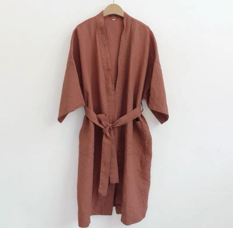 May include: A rust-coloured linen robe with a self-tie belt. The robe has a relaxed fit and is perfect for lounging around the house.