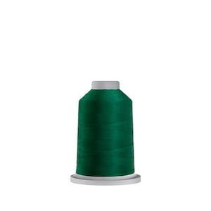 May include: A spool of dark green thread for sewing or embroidery.