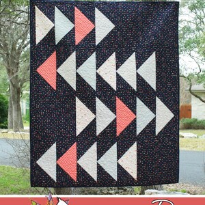 May include: A quilt pattern called "Migration" featuring a black background with white and coral triangles arranged in a diagonal pattern. The quilt is made by Running Doe Quilts for Villa Rosa Designs.