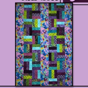 May include: A quilt pattern called "Winter Garden" by Villa Rosa Designs. The quilt is made up of colorful squares in shades of purple, green, blue, and black. The squares are arranged in a grid pattern. The quilt is surrounded by a border of floral fabric.