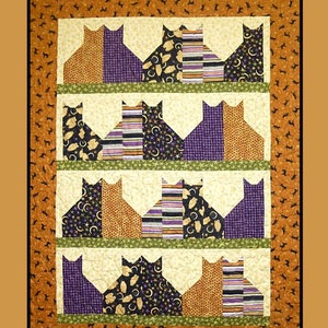 May include: A colorful patchwork quilt with a cat theme. The quilt features rows of cat silhouettes in various patterned fabrics, including orange, purple, and black. The quilt measures 42" x 56". The words "Cat City" are displayed in a stylized font.