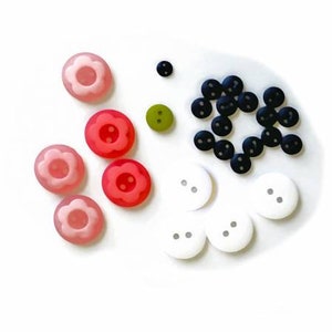 May include: Assortment of colorful buttons in various shapes and sizes, including pink, red, white, black, and green. Some buttons have a flower design.