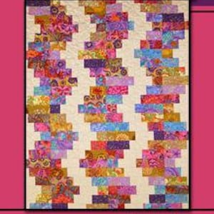 May include: A quilt pattern called "Tulsa Town" by Villa Rosa Designs. The pattern features a colorful, geometric design with a mix of pink, purple, orange, and yellow fabrics.