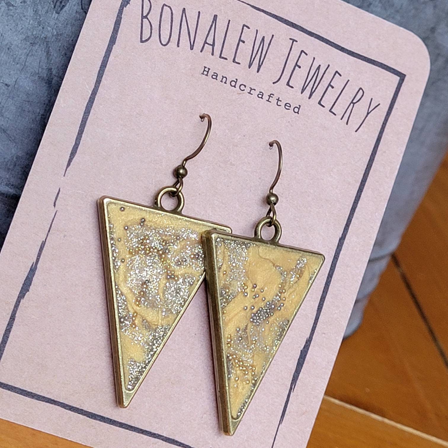 Triangular shaped golden pebbled earrings.