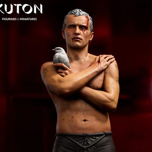 May include: A detailed figurine and bust of a man with a bird, featuring a realistic design. The full-body figure stands on a platform, wearing shorts and sneakers. The bust is orange. The image includes the text "KUTON" and "Lychee Slicer PRE-SUPPORTED".