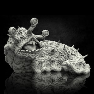 May include: A gray, detailed, 3D printed miniature of a slug-like creature with multiple eyes and sharp spines. The creature has a large, open mouth with teeth and a long tongue.