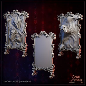 May include: Three ornate, silver-colored, framed mirrors with a decorative design. The left mirror features a sculpted demon emerging from the frame. The right mirror features a sculpted figure with a draped cloth emerging from the frame. The center mirror is blank.