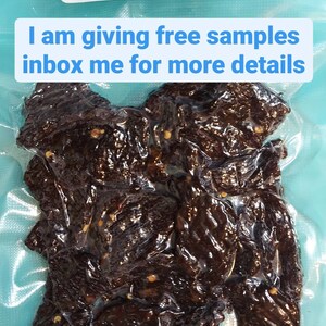 May include: A close-up of a bag of sweet and hot beef jerky. The bag is sealed and the jerky is visible through the plastic. The text on the bag reads "Sweet & Hot Beef Jerky" and "Steve's Homemade Beef Jerky". The text "I am giving free samples inbox me for more details" is written in a pink box on the top of the bag. The text "Visit my Etsy page" is written in a purple box on the bottom of the bag.