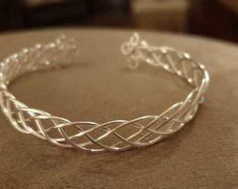 Silver Celtic weave bangle with easy catch and fasten Adjustable.