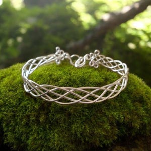Silver Celtic weave bangle with easy catch and fasten Adjustable.