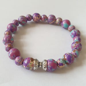 Stretchy natural sea sediment jasper bracelet with tibetan silver space bead.