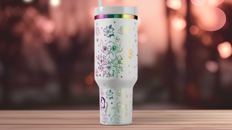 May include: White insulated tumbler with a lid and straw. The tumbler features a design of Stitch from Lilo & Stitch, surrounded by flowers and stars, with a rainbow iridescent finish. The design is in a line art style.